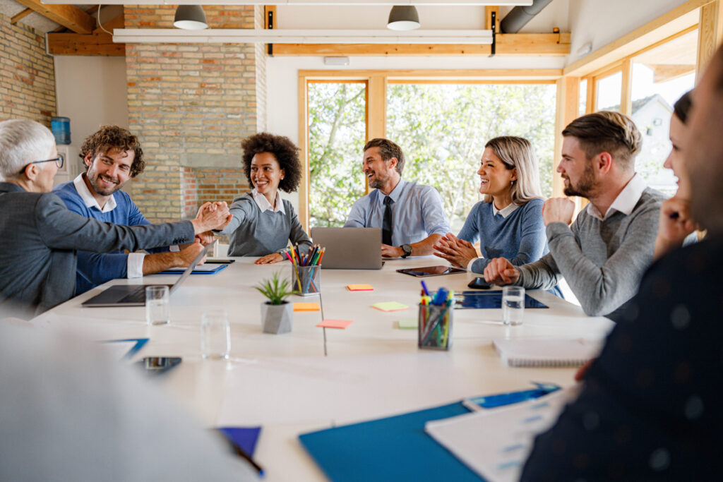 A group of educators in the office is having a meeting and building relationships with each other to develop soft skills for educational leaders.