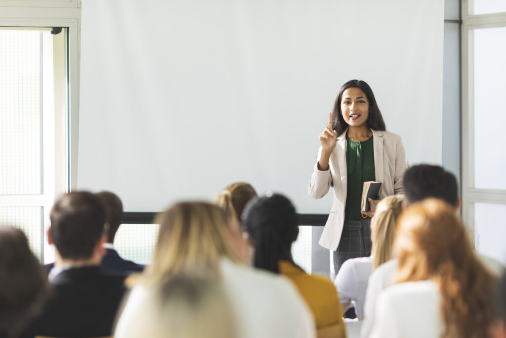 Woman giving a seminar on educational leadership.