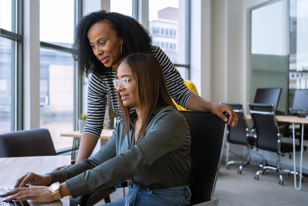 A woman is guiding her colleague through training to create an inclusive environment for all students.